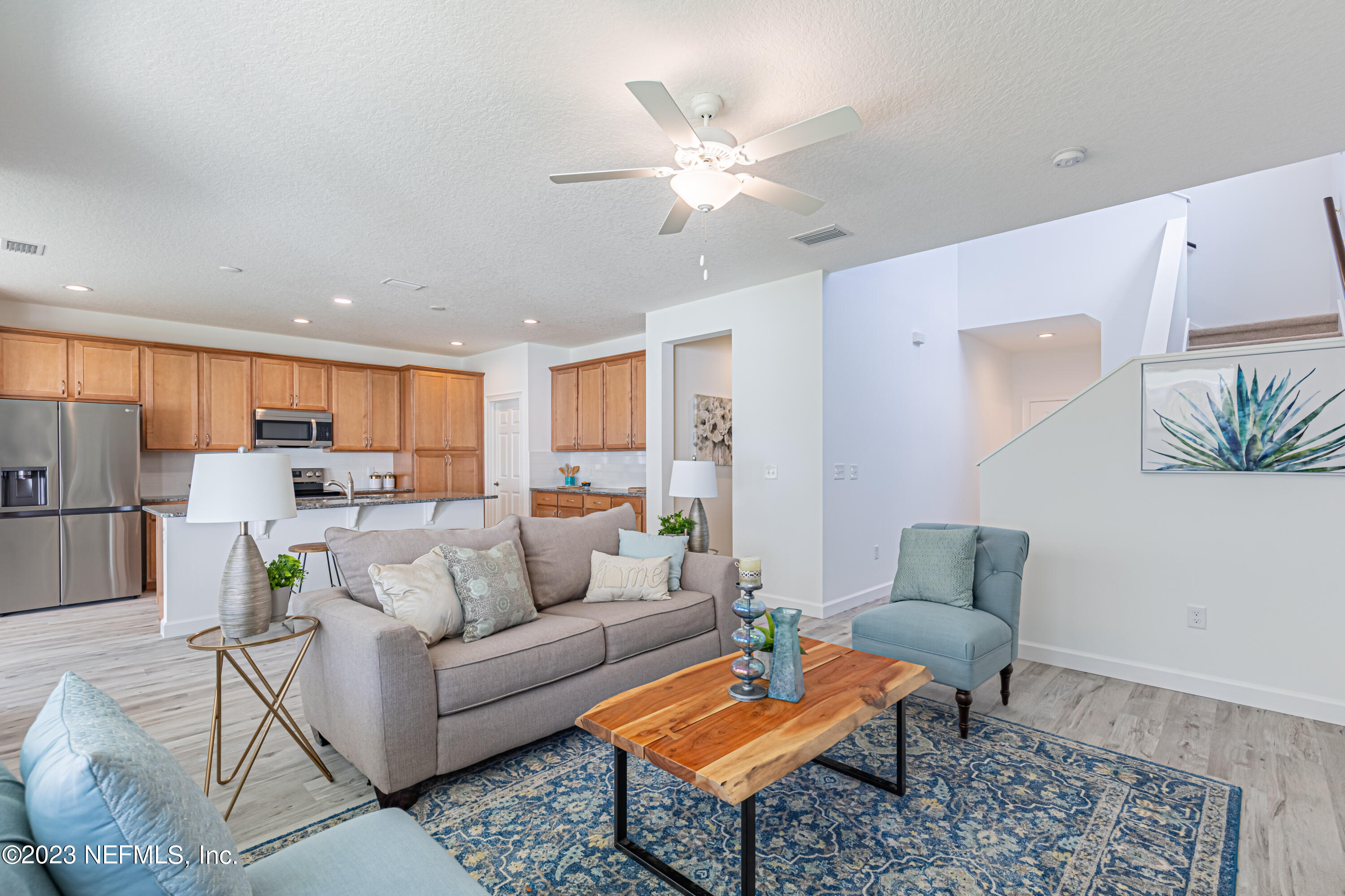3093 Orange Picker Road Jacksonville, FL 32223 - Photo 7 of 39 a living room with furniture and kitchen view