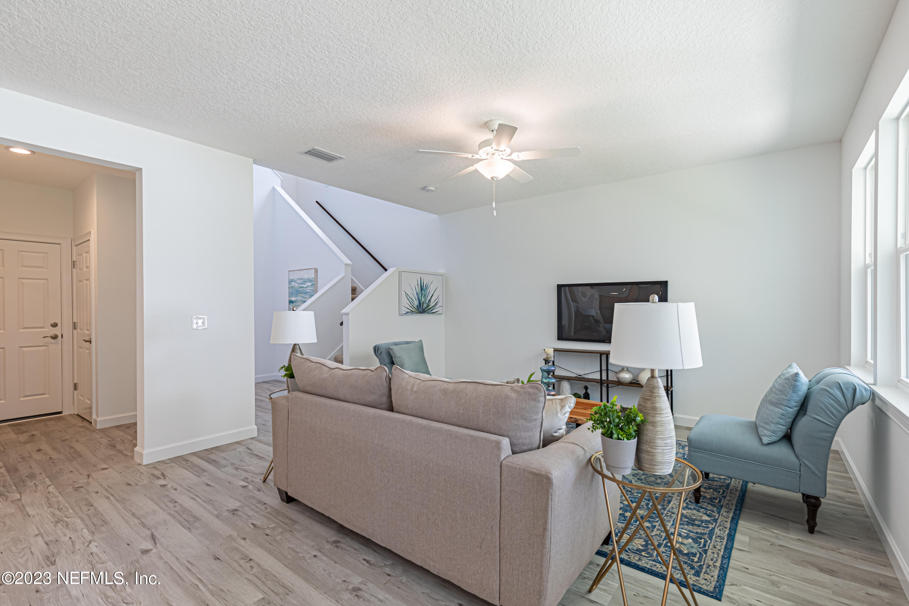 3093 Orange Picker Road Jacksonville, FL 32223 - Photo 8 of 39 a living room with furniture and a wooden floor