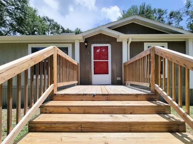 a view of a house with wooden fence