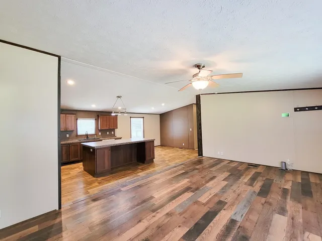 a view of kitchen with a sink and a refrigerator