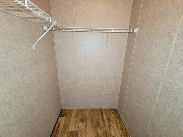 a view of empty room with fireplace and fan