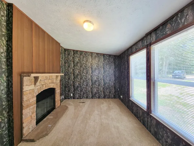a view of empty room with fireplace