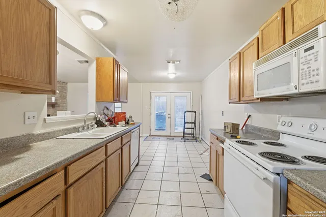 a kitchen with a sink stove and cabinets
