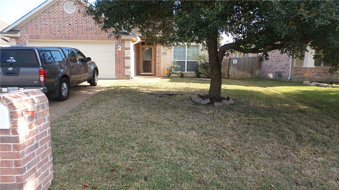 a view of a car park in front of a house
