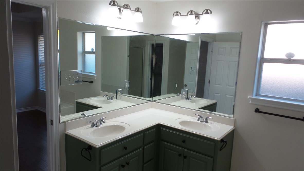 114 Rugen Lane College Station, TX 77845 - Photo 13 of 22 a bathroom with a double vanity sink and mirror