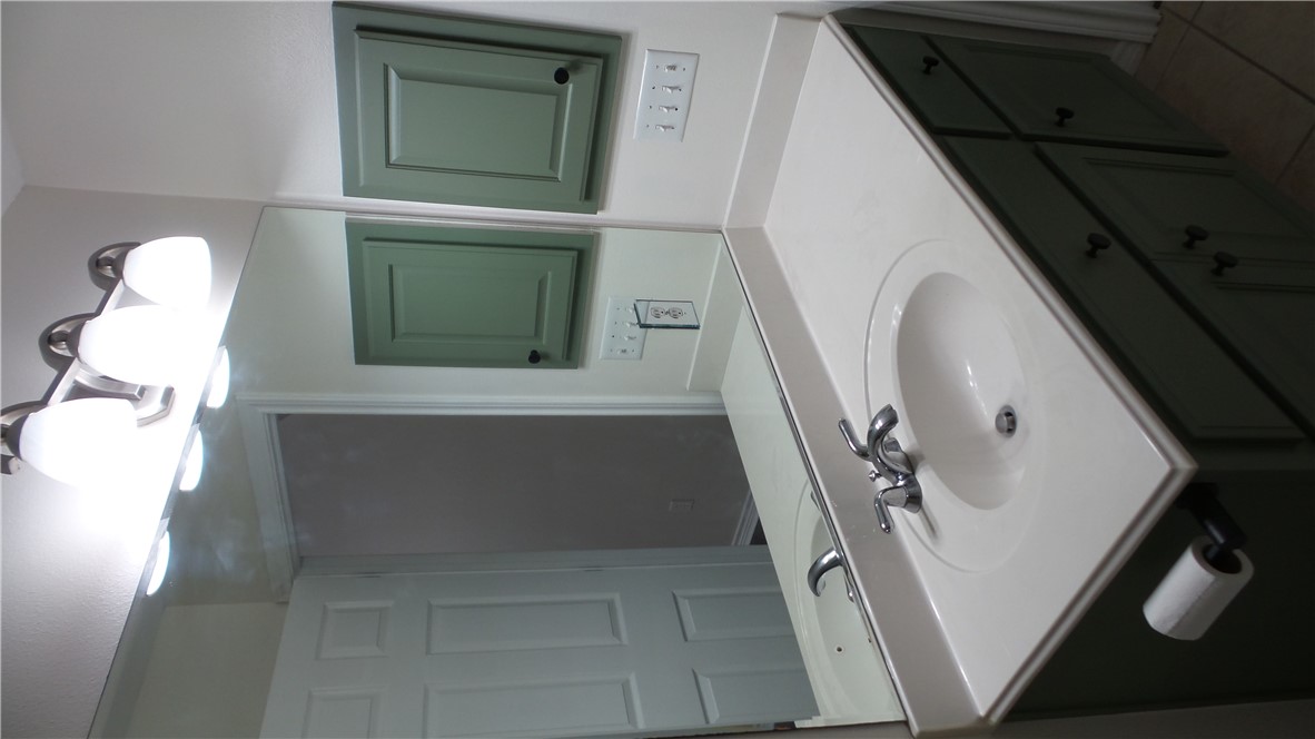 114 Rugen Lane College Station, TX 77845 - Photo 17 of 22 a bathroom with a sink and a mirror