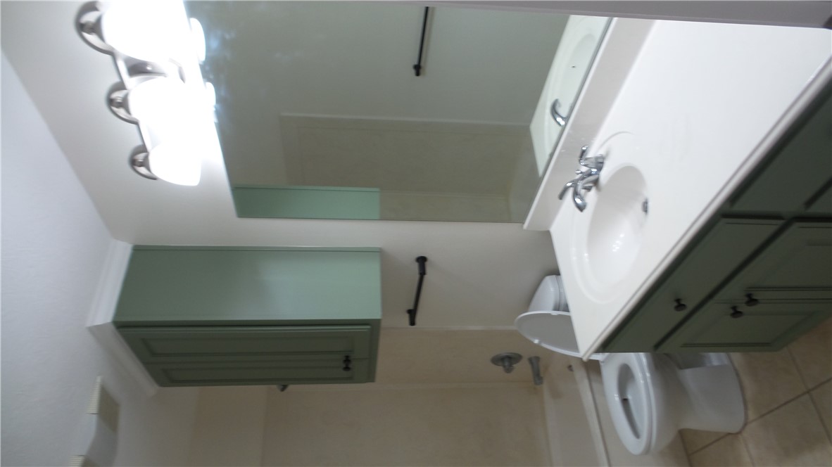 114 Rugen Lane College Station, TX 77845 - Photo 20 of 22 a bathroom with a sink a toilet and mirror