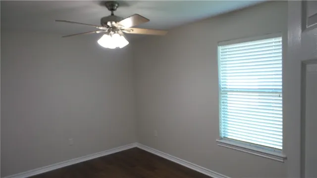 a view of a workspace with a window and a chandelier fan