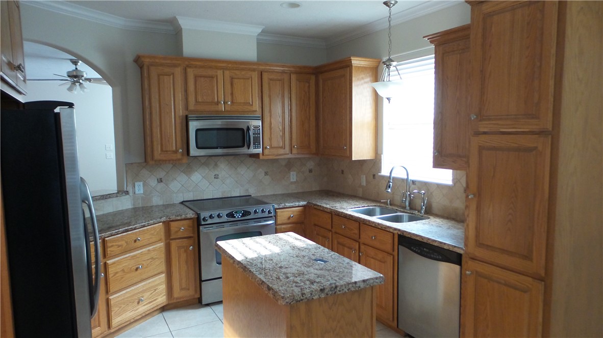 114 Rugen Lane College Station, TX 77845 - Photo 6 of 22 a kitchen with granite countertop a sink stove and cabinets