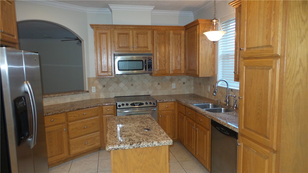114 Rugen Lane College Station, TX 77845 - Photo 8 of 22 a kitchen with stainless steel appliances granite countertop a refrigerator sink and stove