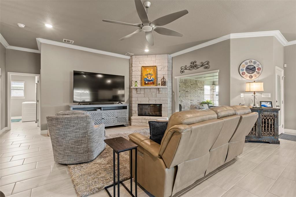 828 Agile Street Hewitt, TX 76643 - Photo 6 of 30 a living room with fireplace furniture and a flat screen tv