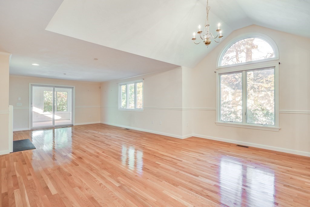 16 North Ridge Road, Unit 16 Mashpee, MA 02649 - Photo 13 of 42 a view of an empty room with wooden floor and a window