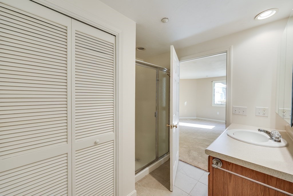 16 North Ridge Road, Unit 16 Mashpee, MA 02649 - Photo 26 of 42 a bathroom with a sink and a mirror