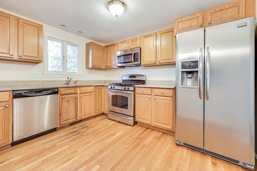16 North Ridge Road, Unit 16 Mashpee, MA 02649 - Photo 10 of 42 a kitchen with white cabinets stainless steel appliances and sink