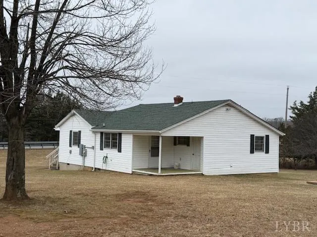 a front view of a house with a garden and trees