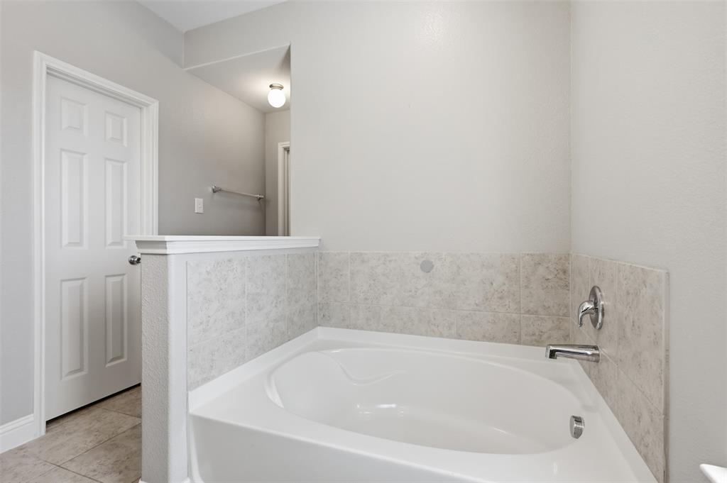 717 Allbright Road Celina, TX 75009 - Photo 20 of 37 Garden tub, dual sinks, linen closet. Separate walk in shower