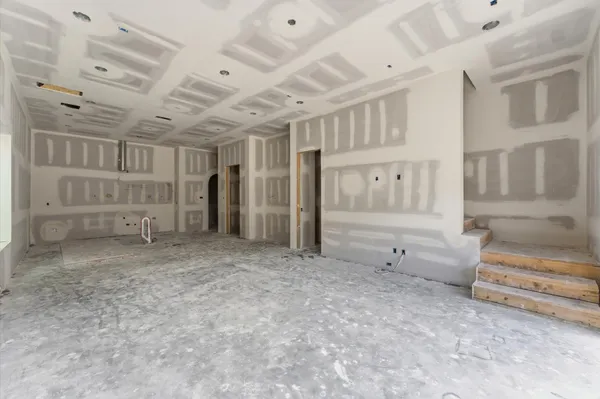 a view of an empty room with a fireplace and a window