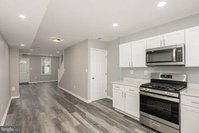 a kitchen with stove cabinets and stainless steel appliances
