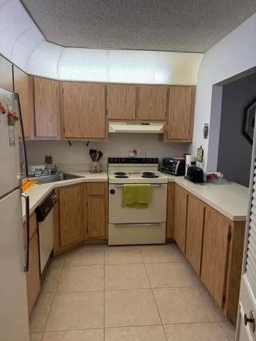 a kitchen with a stove sink and cabinets