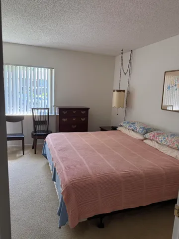 a bedroom with a bed and window