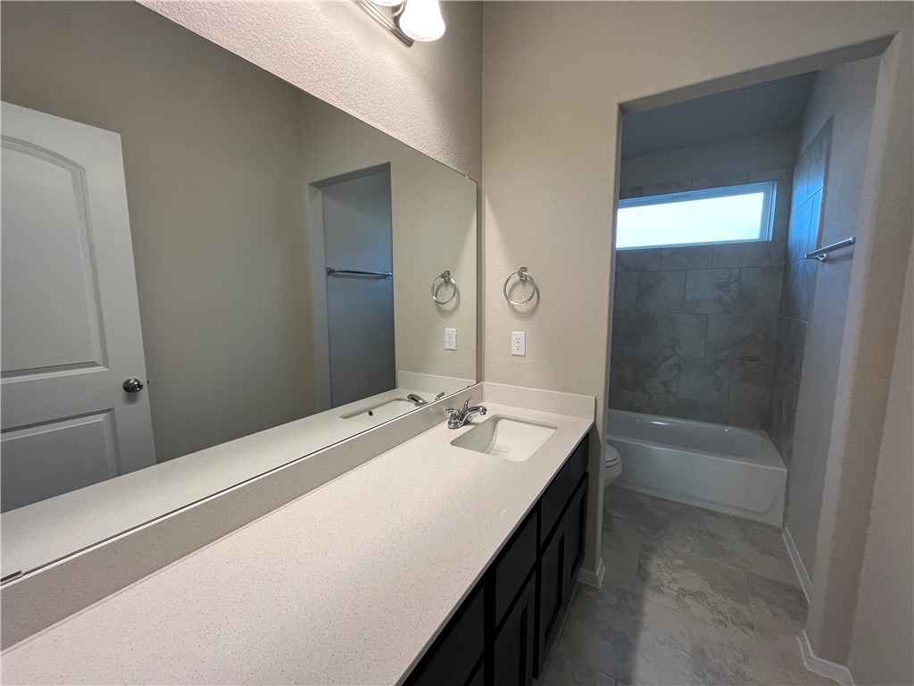 128 Bright Flora Lane Maxwell, TX 78656 - Photo 13 of 14 a bathroom with a sink a bathtub and a shower