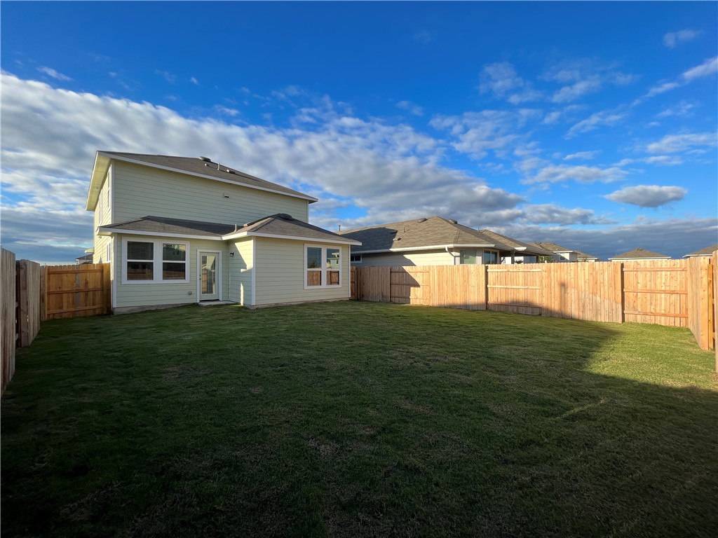128 Bright Flora Lane Maxwell, TX 78656 - Photo 14 of 14 a view of a house with a backyard