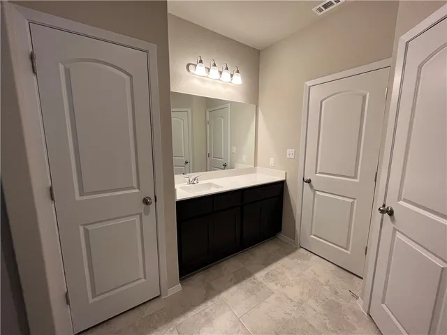 a bathroom with a double vanity sink and a mirror