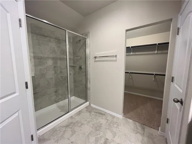 a bathroom with a glass shower door
