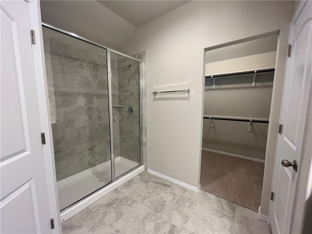 128 Bright Flora Lane Maxwell, TX 78656 - Photo 10 of 14 a bathroom with a glass shower door