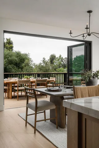 a balcony with wooden floor and furniture