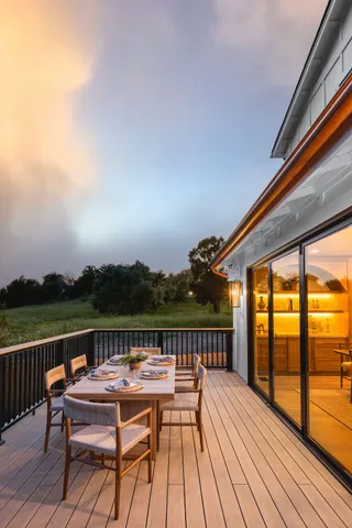 a en suite bathroom with double vanity a mirror and a bathtub