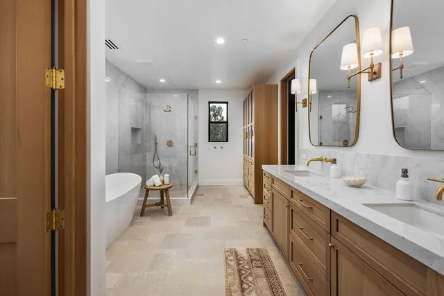 a white bath tub sitting next to a shower