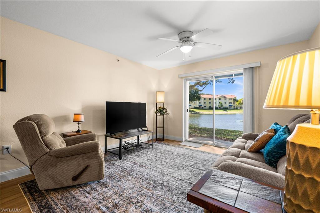 8264 Key Royal Circle, Unit 812 Naples, FL 34119 - Photo 11 of 21 Living area with ceiling fan and wood finished floors
