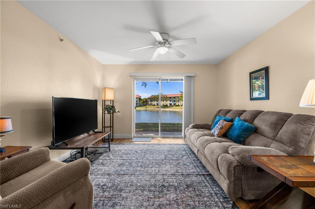 8264 Key Royal Circle, Unit 812 Naples, FL 34119 - Photo 12 of 21 Living room featuring a ceiling fan and wood finished floors
