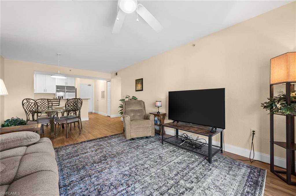 8264 Key Royal Circle, Unit 812 Naples, FL 34119 - Photo 13 of 21 Living area featuring light wood-style flooring and ceiling fan
