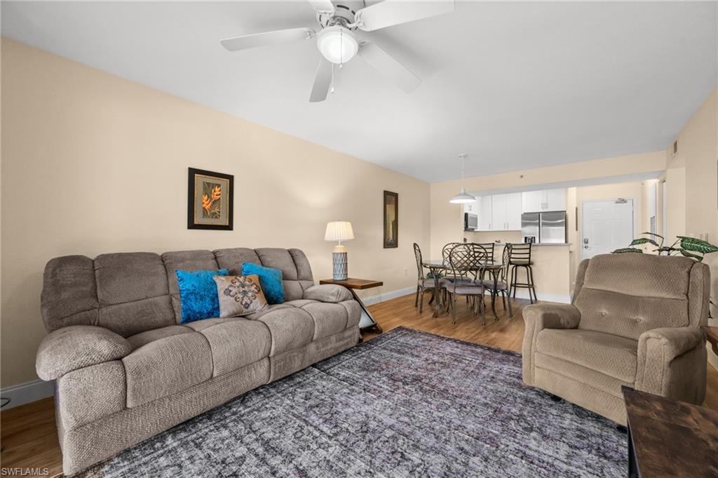 8264 Key Royal Circle, Unit 812 Naples, FL 34119 - Photo 14 of 21 Living area with wood finished floors and a ceiling fan
