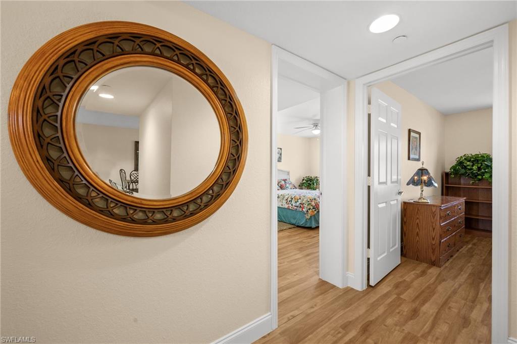 8264 Key Royal Circle, Unit 812 Naples, FL 34119 - Photo 15 of 21 Hall with baseboards and light wood finished floors