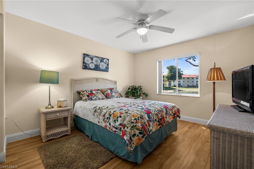 8264 Key Royal Circle, Unit 812 Naples, FL 34119 - Photo 16 of 21 Bedroom featuring light wood-type flooring and a ceiling fan