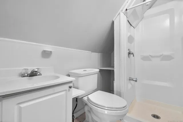 a white toilet sitting next to a bathroom sink