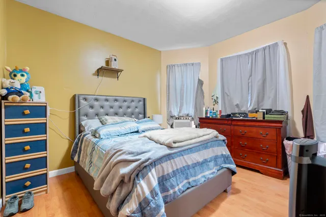 a bedroom with a bed and a dresser in it