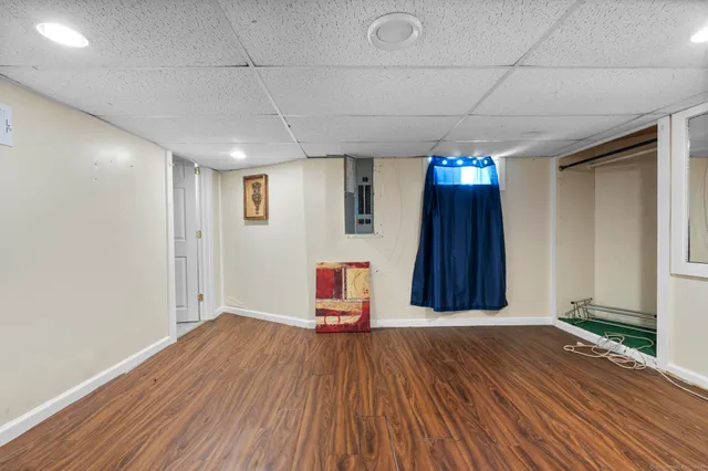 a view of a room with wooden floor and stairs