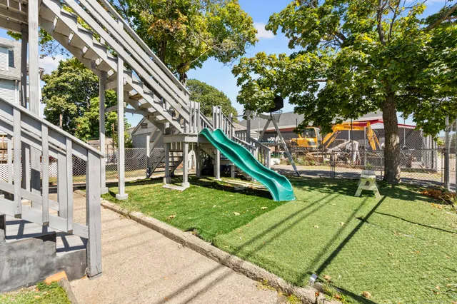 a view of an house with backyard and sitting area