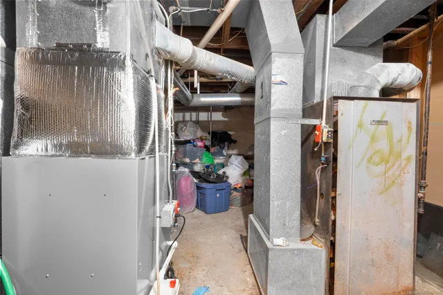 a utility room with lots of clutter and refrigerator