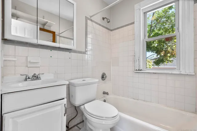 a bathroom with a toilet a sink and a bathtub