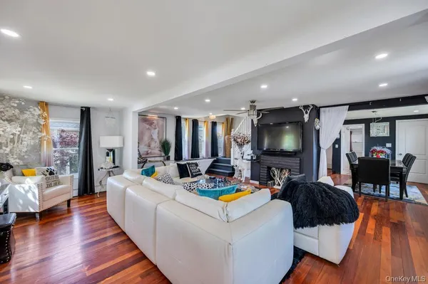 a living room with furniture fireplace and flat screen tv