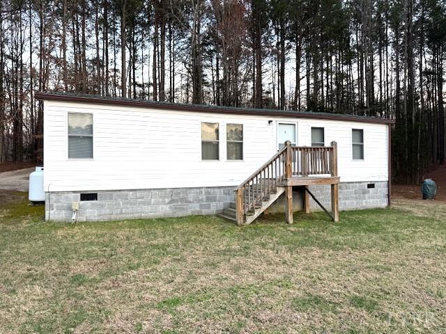 a view of a house with a yard and sitting area