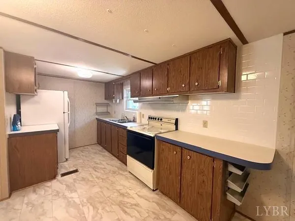a kitchen with stainless steel appliances granite countertop a sink and cabinets