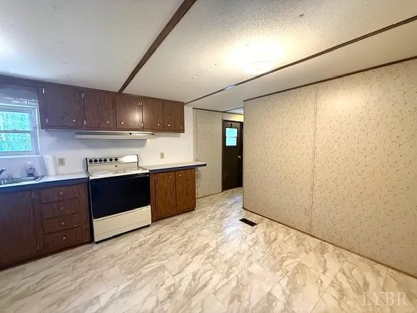 a kitchen with stainless steel appliances granite countertop a sink a refrigerator and a microwave