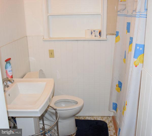 1533 Leslie Road Baltimore, MD 21222 - Photo 9 of 15 a bathroom with a sink a toilet and a shower
