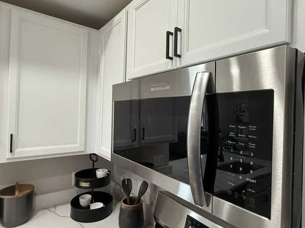 a kitchen with a refrigerator and a stove top oven
